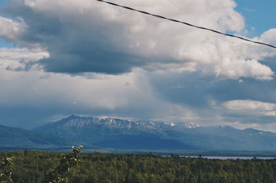 Scenic view of mountains against cloudy sky