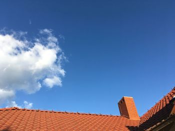 Low angle view of building roof against sky