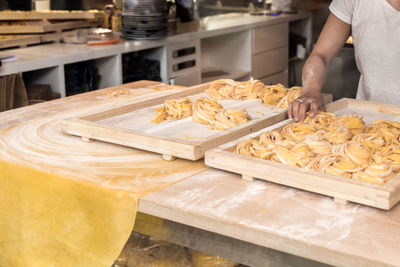 Midsection of person preparing food in kitchen