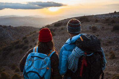 Rear view of women looking at mountains during winter