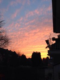 Low angle view of built structure against sky at sunset