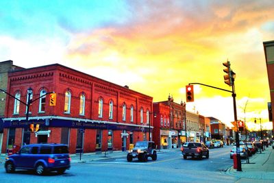 Cars parked on street during sunset