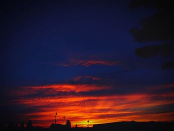 Silhouette of tree against dramatic sky