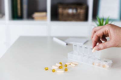 Medical pill box with tablets for daily take with drugs, capsules. woman get her daily vitamins