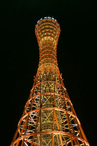 Low angle view of illuminated tower against sky at night