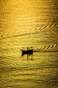 High angle view of silhouette boat on sea during sunset