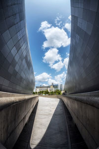 Modern buildings in city against cloudy sky