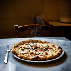 Close-up of pizza in plate on table