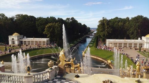 Fountain by trees against sky