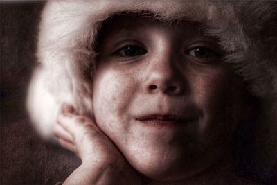 Close-up portrait of boy wearing fur hat