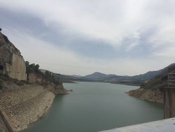 Scenic view of lake by buildings against sky