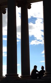 Tourists against cloudy sky