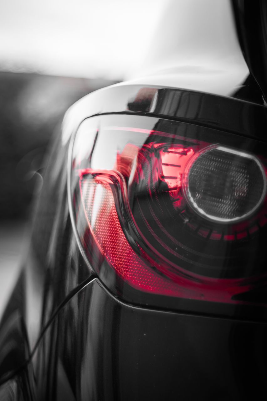 CLOSE-UP OF RED CAR ON MIRROR