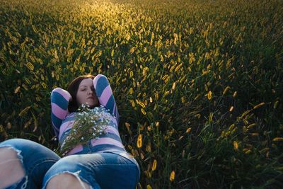 Close-up of woman lying on grass