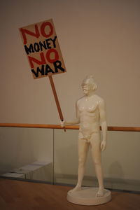 Low section of person standing by text on wall