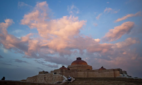 Low angle view of building against cloudy sky