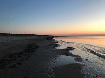 Scenic view of sea against clear sky during sunset