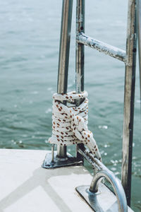 Close-up of rope tied to pole on ship