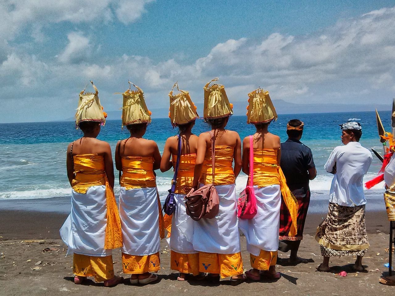 in a row, full length, religion, outdoors, rear view, traditional clothing, sky, cloud - sky, spirituality, people, water, day