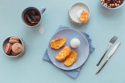 French fried toast with tea, boiled eggs and fresh yogurt. tasty farmer breakfast. flat lay