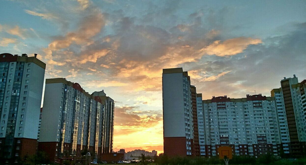 building exterior, architecture, sunset, built structure, city, sky, cloud - sky, orange color, residential building, building, residential structure, skyscraper, cloud, cityscape, cloudy, residential district, modern, outdoors, city life, low angle view