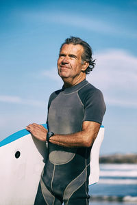 Man standing by sea against sky