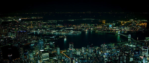 High angle view of illuminated city buildings at night