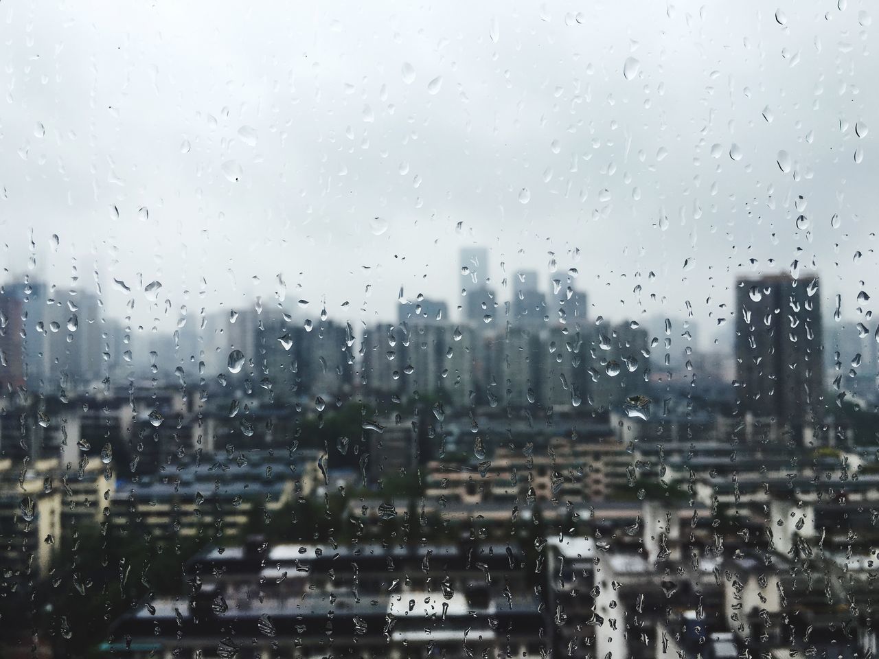 VIEW OF CITYSCAPE THROUGH WINDOW