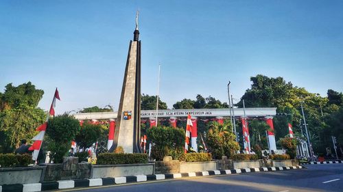 View of flags in city against clear sky