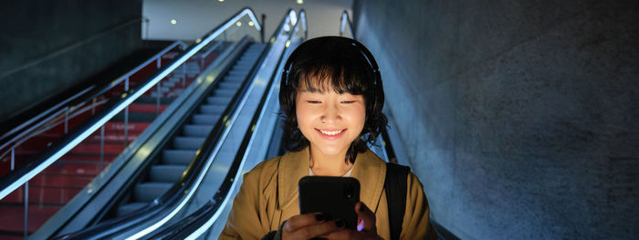 Portrait of young woman using mobile phone