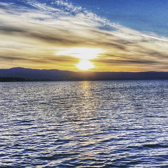 sunset, water, scenics, tranquil scene, beauty in nature, tranquility, waterfront, sky, rippled, sea, nature, sun, idyllic, cloud - sky, sunlight, reflection, orange color, lake, mountain, cloud