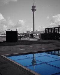 Communications tower against sky in city