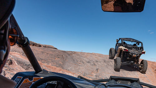 Full frame view of a 4x4 tour in rugged sandstone terrain on a trail called hell's revenge