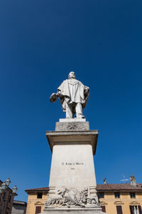 Low angle view of statue against blue sky
