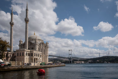 View of bridge over river against cloudy sky