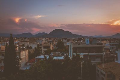 Buildings against cloudy sky during sunset