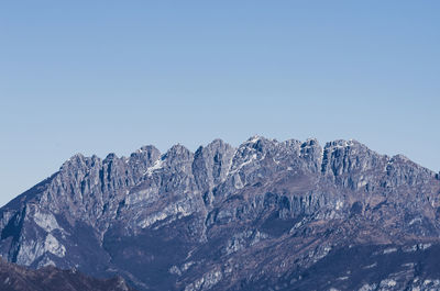 Scenic view of snowcapped mountains against clear sky