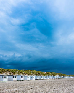 Scenic view of beachhouses against blue sky