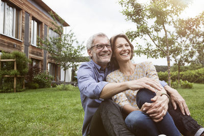 Happy mature couple sitting in garden