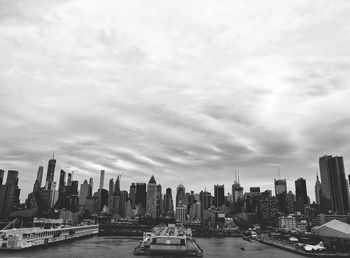 View of buildings in city against cloudy sky