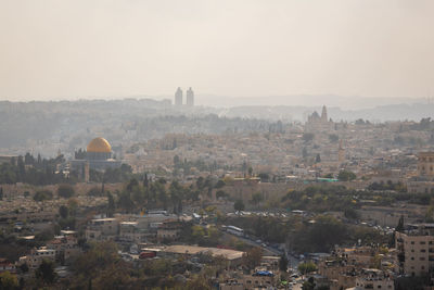 Aerial view of townscape against sky in city