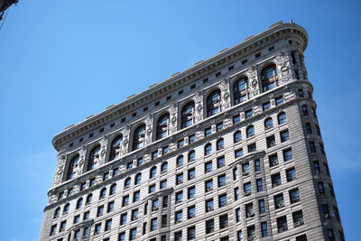 Low angle view of historic flatiron building against sky