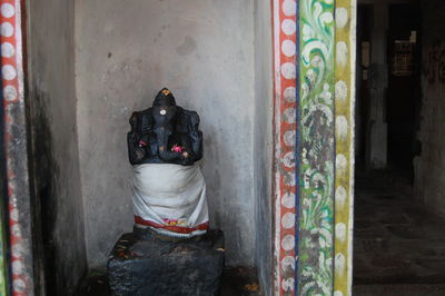 Ganesha idol covered in white cloth at temple