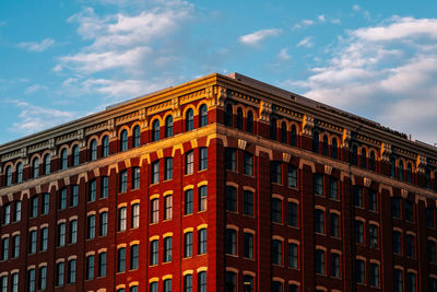 Low angle view of building against cloudy sky