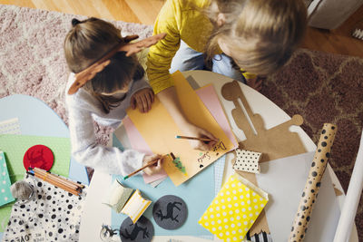 Sisters drawing at home during christmas