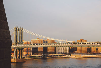 Bridge over river against buildings