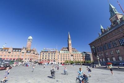 Group of people in front of buildings