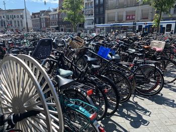 Bicycles parked on street against buildings in city