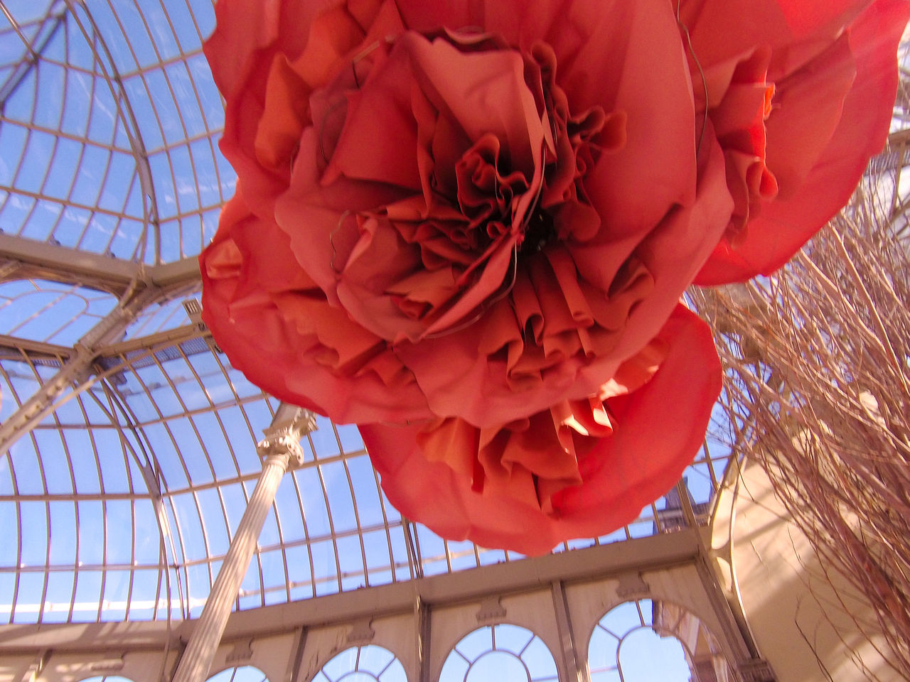 LOW ANGLE VIEW OF RED FLOWER HANGING IN CEILING