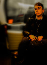 Mid adult man sitting in train